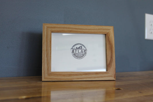 White oak 4 x 6 desktop frame with an Atlas Wood logo print on a wood tabletop