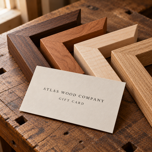 Atlas Wood Company gift card in front of walnut, cherry, maple and white oak frame corners