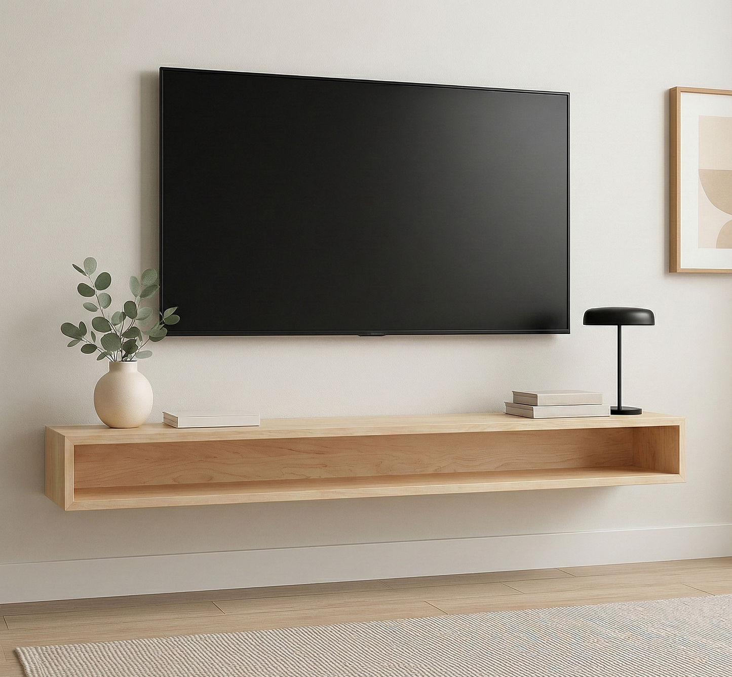 Wooden TV stand with a television mounted on a wall, featuring a vase with greenery and a lamp.