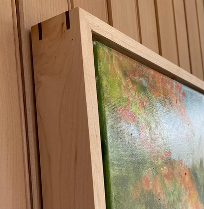 a close up of a wooden frame with a painting on it