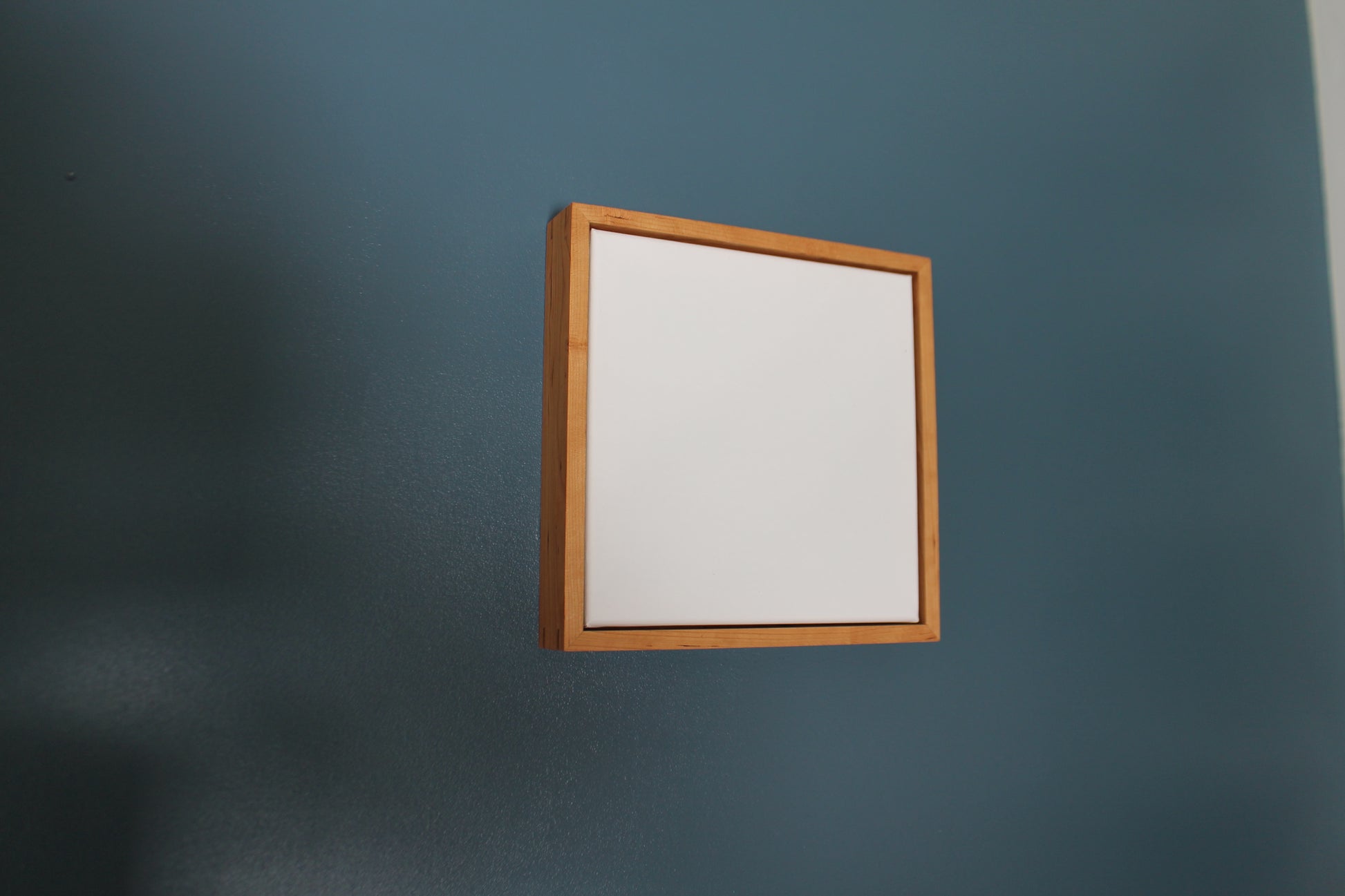 a mirror hanging on a wall next to a blue wall