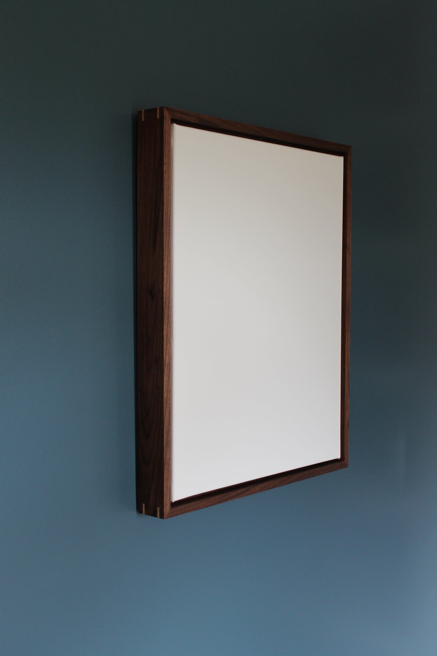 a ceiling light with a wooden frame hanging from the ceiling