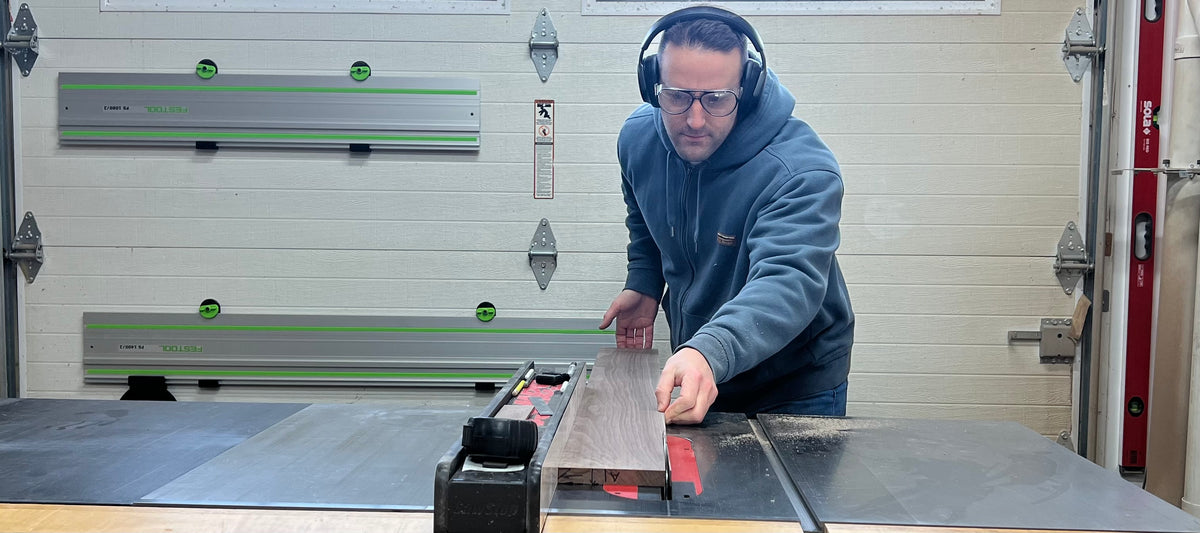 Andrew cutting a walnut board on the table saw in his Pennsylvania shop