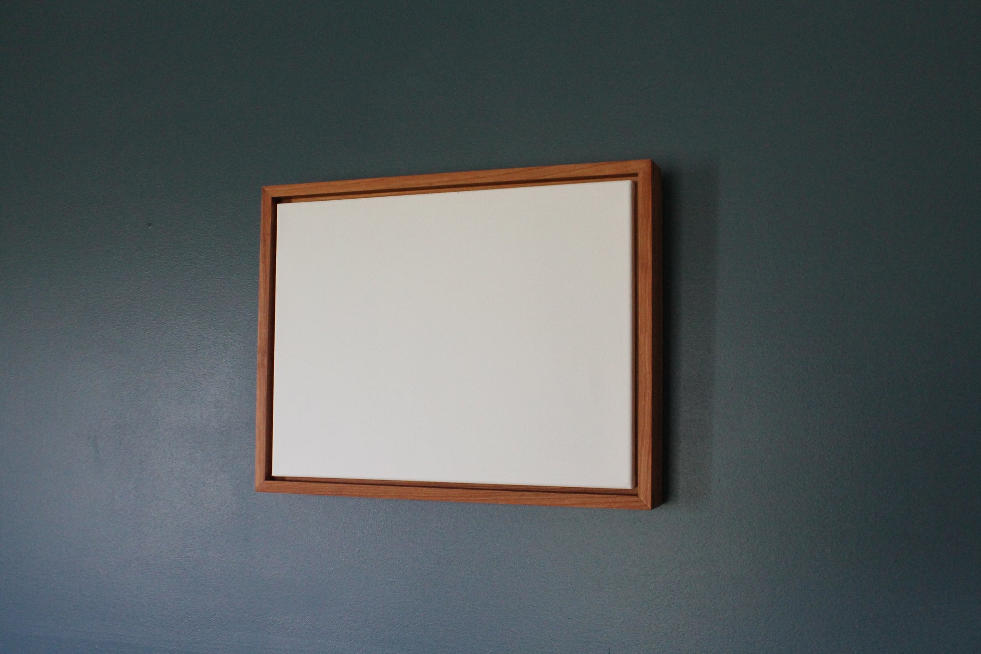 a mirror hanging on a wall in a room