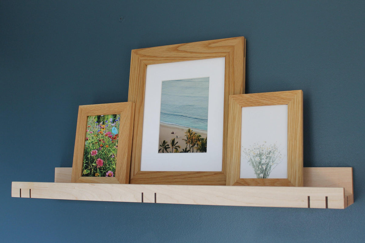 Maple 3-inch ledge shelf holding framed flower, beach and botanical prints