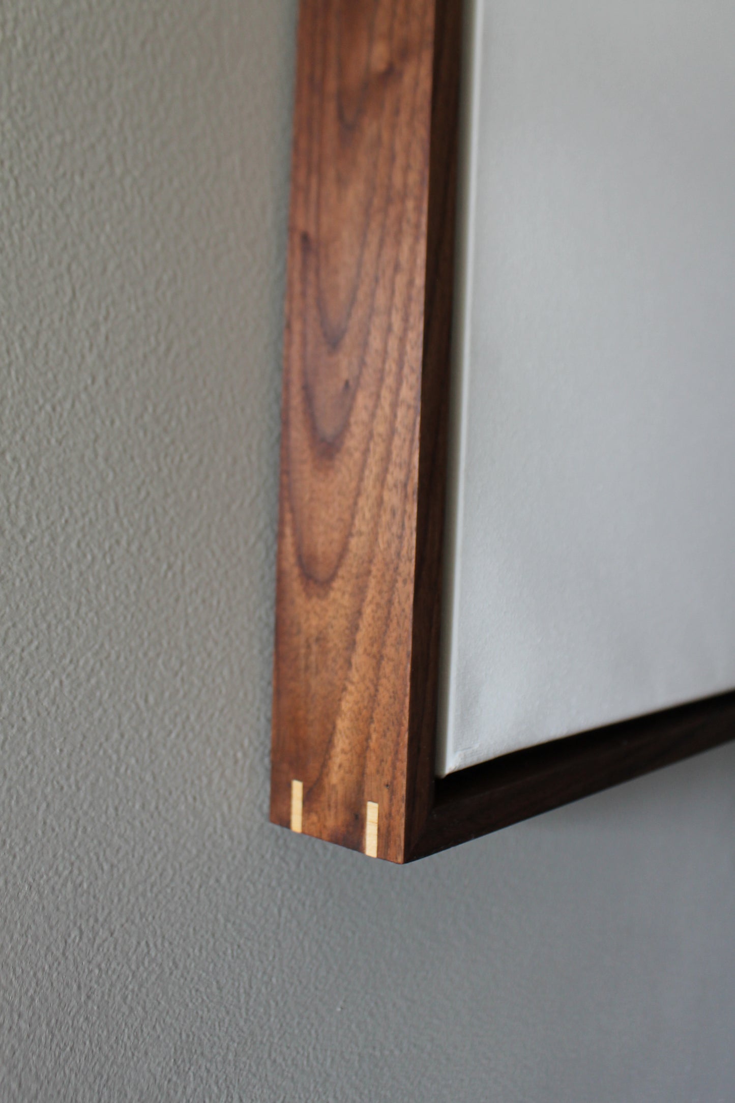 a close up of a wooden shelf on a wall