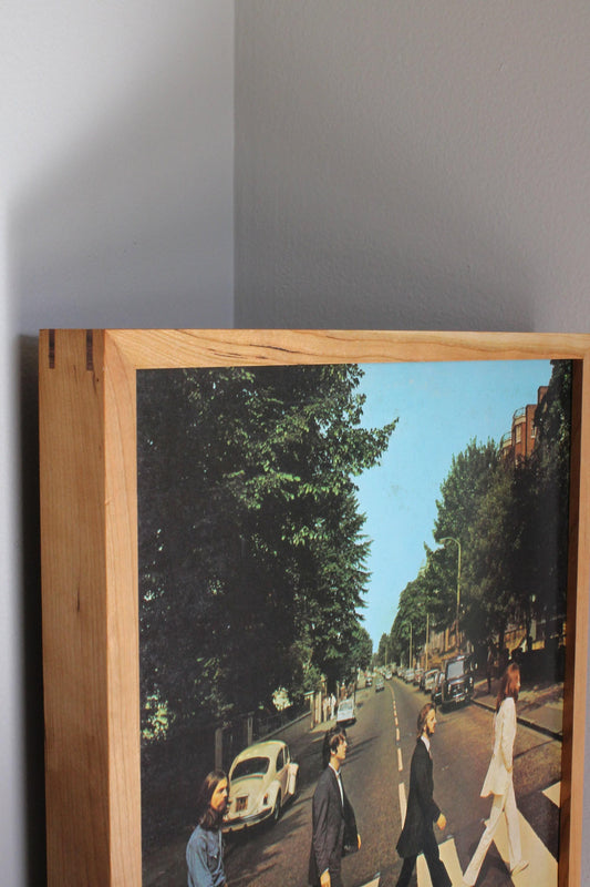 Close-up of a cherry album frame corner with Abbey Road record sleeve