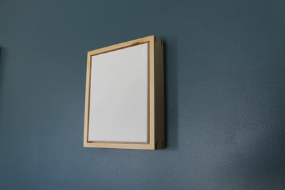 a picture frame hanging on a wall next to a mirror